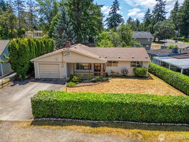 Home is fully fenced and sits back off the road. Hedge brings nice privacy for the front yard and covered porch.