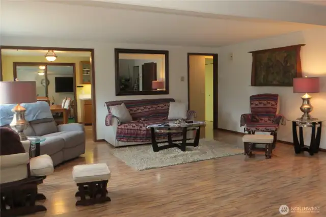 LIVING ROOM OPENS UP TO THE KITCHEN/DINING ROOM AS WELL AS ENTRANCE TO THE BEDROOMS ON THE RIGHT!