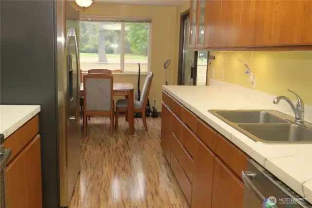 VIEW OF THE KITCHEN, DINING ROOM AND FIFTH FAIRWAY THROUGH THE LARGE WINDOW!