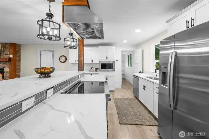 Chef's dream kitchen with abundant cabinetry, beautiful quartz counters, stainless steel appliances & huge island - great for gathering and entertaining!