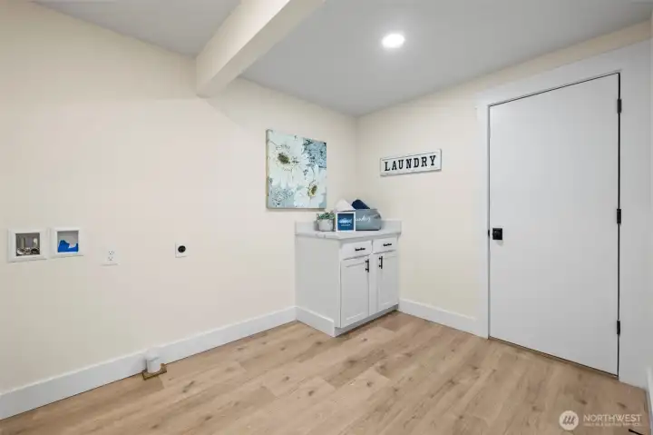 Spacious laundry room with door to garage.