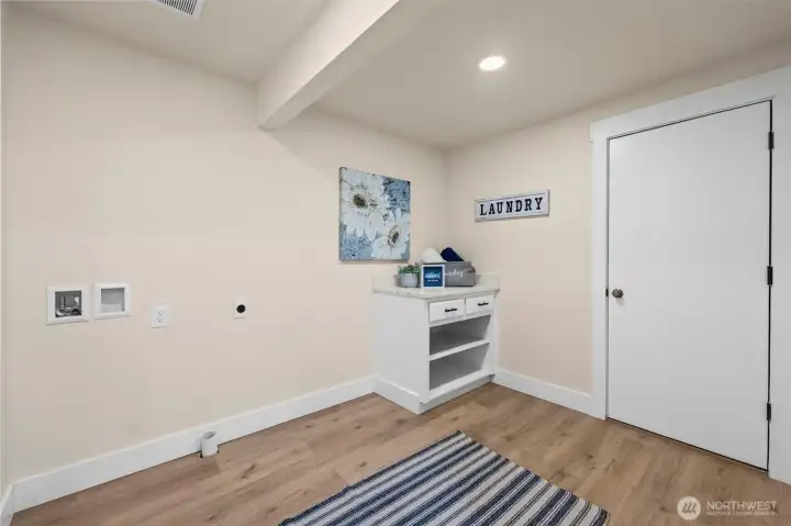 Spacious laundry room with door to garage.