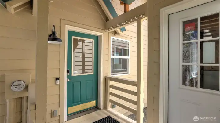 Front door with covered area. Door to the right is the access to potential living quarters below the garage with roughed-in plumbing-565 unfinished sqft