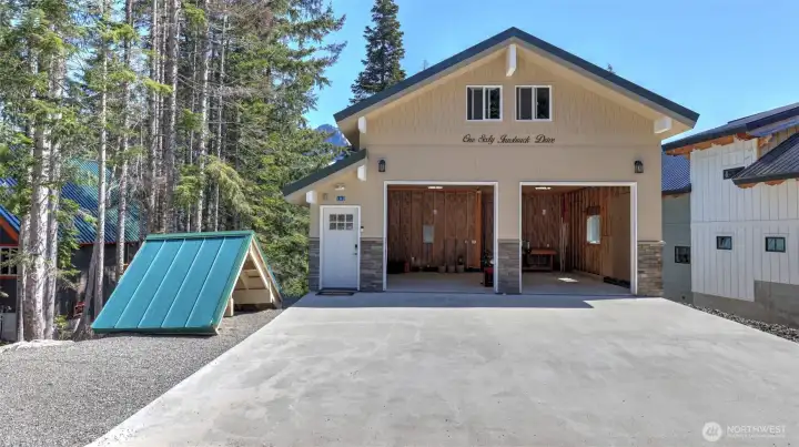 Newly built 2-car garage features 9' doors with upper and lower unfinished living spaces.