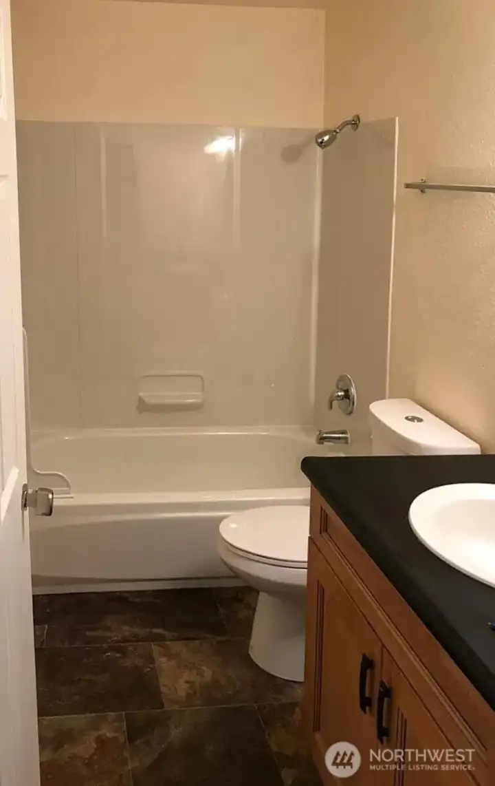 Easy to clean bathroom floors and vanity with plenty of storage space!