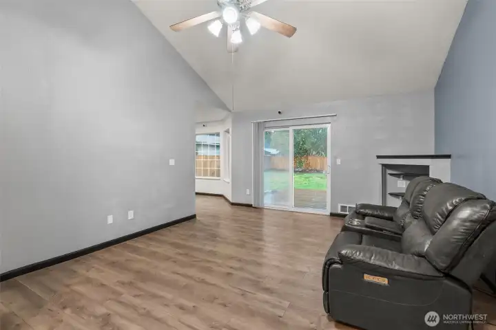 Living room with vaulted ceiling and view to rear yard.