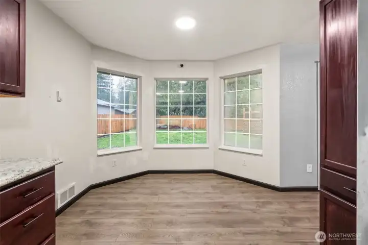 Cozy eating nook conveniently located directly off the kitchen, providing an inviting space for casual meals and everyday gatherings.