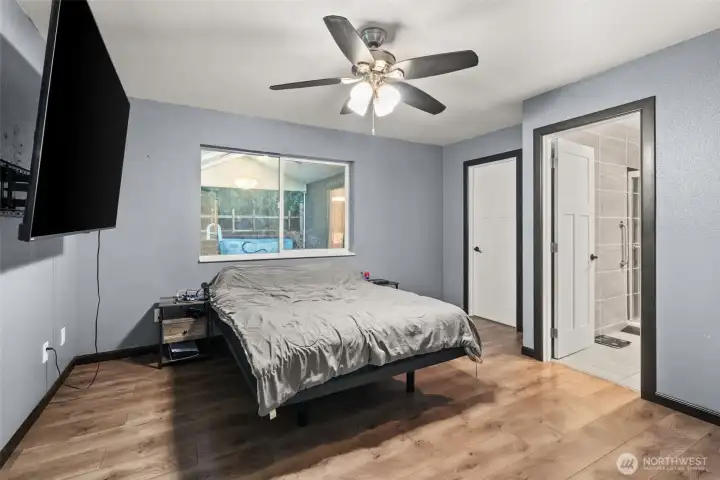 Primary bedroom with 3/4 bath and walk-in closet.