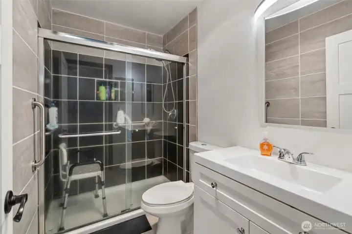 Primary bathroom has built-in grab bars for the shower, tile walls, and a recessed medicine cabinet. Updated exhaust fan lights with Bluetooth speakers for music, news, traffic, or podcasts, and a 1.5 sone exhaust fan.