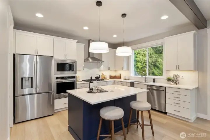 Chef-inspired kitchen with upgraded Kitchenaid appliances and generous prep space.