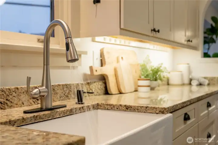 Kitchen updates include a no touch faucet and cabinet underlighting.