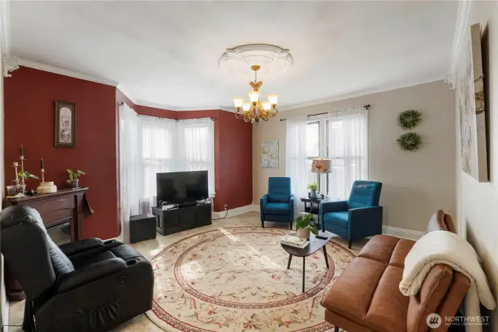 Large living room with tall ceilings, lots of natural light through the large windows and bay wondow.