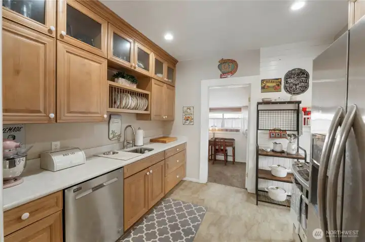 Beautifully remodeled galley kitchen with quality maple cabinets and stainless appliances