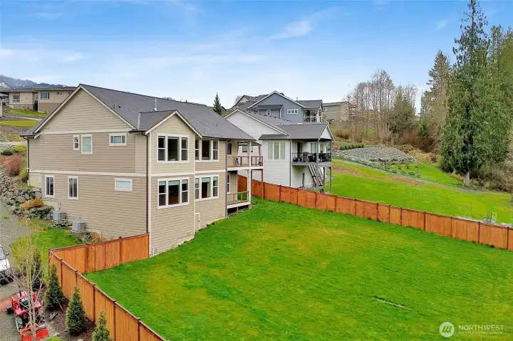 An almost 1/2 acre lot with a new fence surrounding the backyard