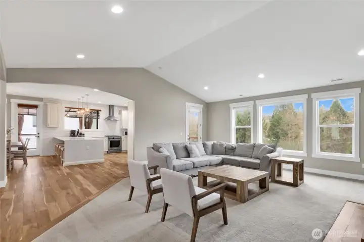 The great room is open to the chef's kitchen and dining room