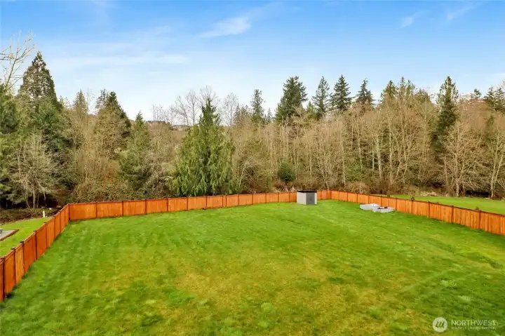 Huge fenced yard that gently slopes to the greenbelt