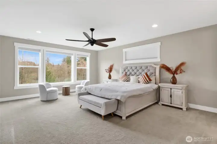 The primary suite is airy, bright, and spacious