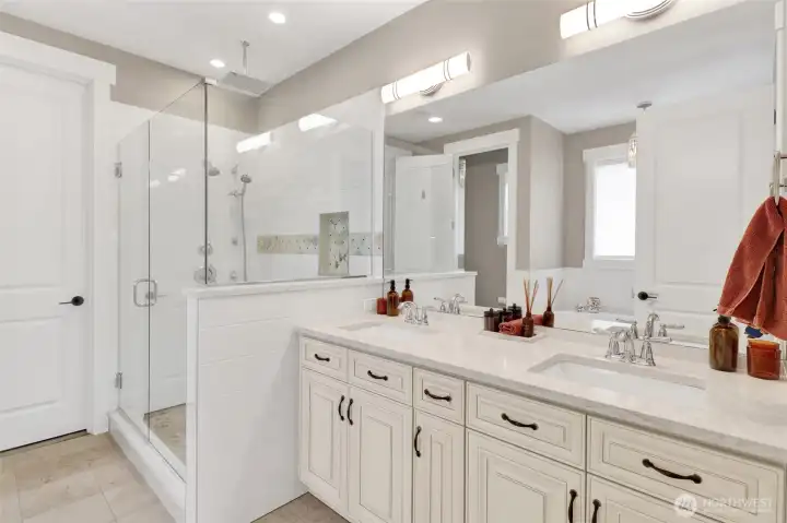 The primary bath is stunning! Double sinks, large shower, soaker tub, private toilet, and a large walk-in closet