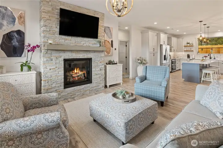 Entering through the front door, you’re welcomed into a bright, open-concept living room that flows seamlessly into the kitchen, creating an inviting and connected main living space.