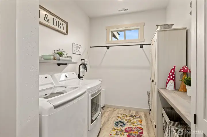 The utility/laundry room is conveniently located on the same end of the home as the primary suite, offering added ease and functionality for daily living.