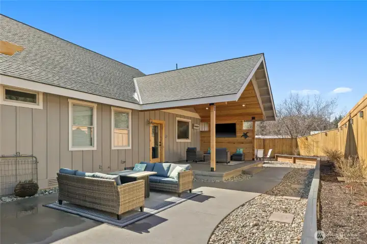 The outdoor living area, framed by a cedar privacy fence, is truly second to none—offering a private and inviting setting for relaxation and entertaining.