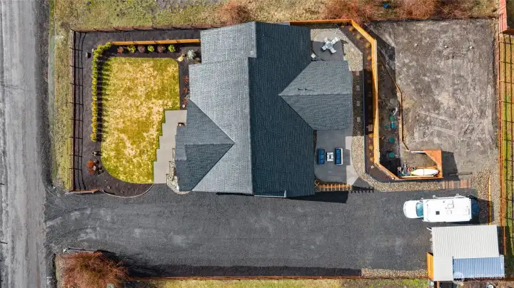 This aerial view of the lot configuration provides a clear overview of the property layout and how the space is thoughtfully utilized. The septic drainfield is on the opposite side of the outdoor living area and privacy deck.