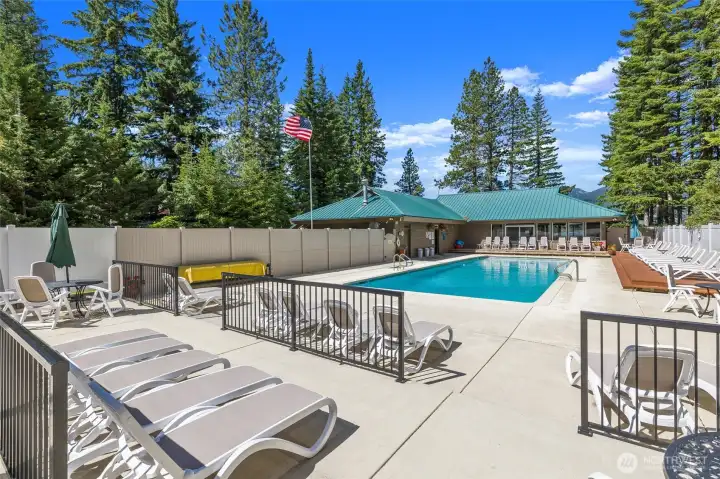 The beach club features a welcoming lodge, an outdoor swimming pool, and pickleball courts, offering a variety of amenities for recreation.