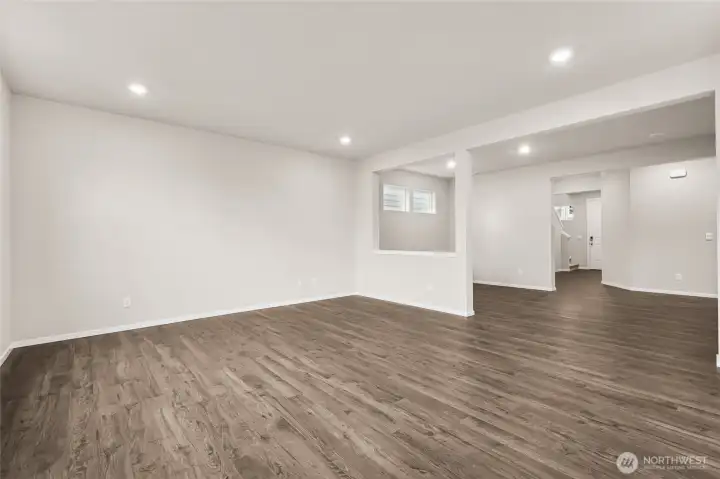 Wide-angle view of the open-concept living room, dining room, and entryway. Photos are representative only and may display different color packages and/or upgrades.