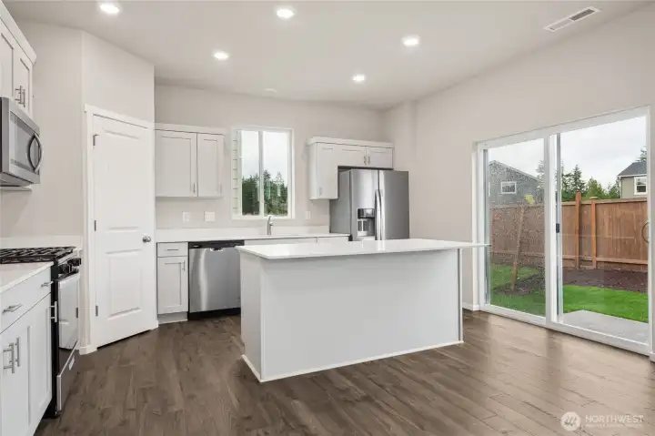 Kitchen with angle showing slider to outdoors. Photos are representative only and may display different color packages and/or upgrades.