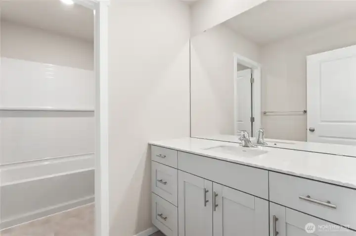 Upstairs guest bathroom with separation between shower and vanity space. Photos are representative only and may display different color packages and/or upgrades.
