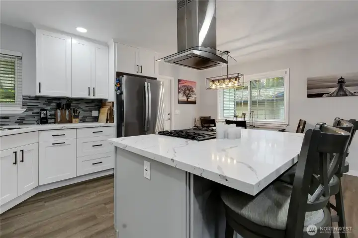 Farm style all wood cabinets with handles, updated lighting, wood wrapped windows.