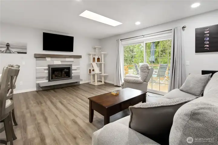 Another view of the family room. The fireplace is gas upstairs and there is a wood burning fireplace downstairs. A  closer view of the deck to your right.