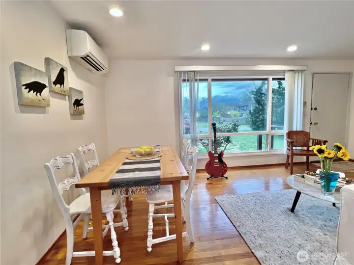 The large front window with vertical blinds allows more light from the east facing front yard. With no obstructions the it's a bright room all day with the help of a skylight illuminating the living room and hallway.