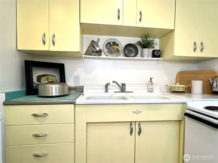 The original Youngstown steel cabinets with the chrome handles are still in great shape, the original double sink could be refinished for decades more life.