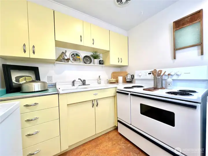 The eco-friendly marmoleum flooring is newer and adds to the retro linoleum vibe. The stove is the 40" orginal width.