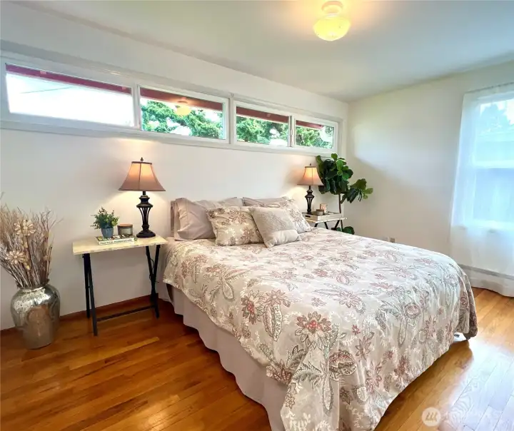 The larger. bedroom has clerestory windows adds to the natural light while providing privacy and is a favorite feature of mid-century homes.