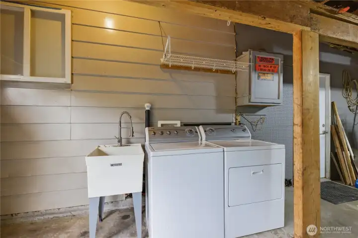 Laundry area located in garage with easy access