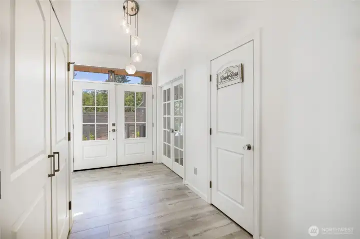 Main Entrance french doors leading to family room Coat closet on left and 1/2 bath on right Main Entrance french doors leading to family room Coat closet on left and 1/2 bath on right