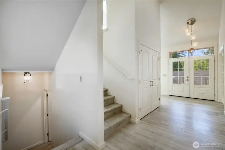 Looking at front door standing next to stairwell to garage level and up to 2nd level Looking at front door standing next to stairwell to garage level and up to 2nd level
