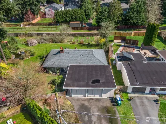 Aerial view showing gardens, fence and alley behind the house that leads to the elementary school and Bridle Trails State Park