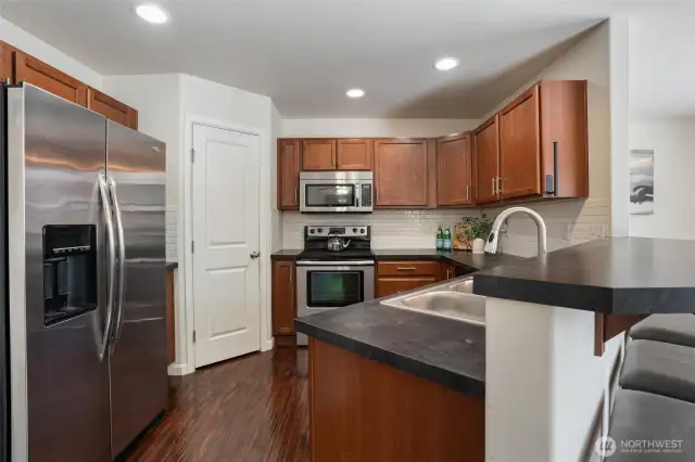 Open concept kitchen features a spacious pantry for all of your Costco runs.