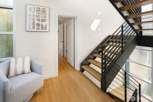 -Obscured glasswork shoots up from the main to the rooftop deck, offering both privacy and point of view.