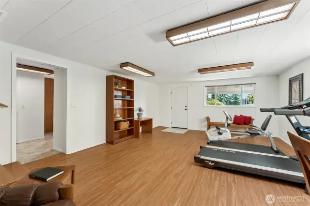 The family room space also has an exterior door to 2 car covered carport and the doorway to your left leads to a half bath and huge laundry room/storage area!