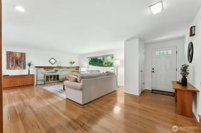 Enter to gleaming hardwoods, a spacious living room and a beautiful stone, woodburning fireplace.