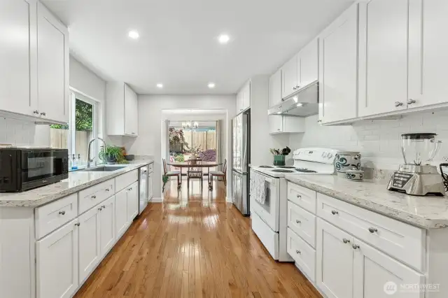 You'll love creating creating culinary delights in your bright kitchen with beautiful new, white shaker cabinets, granite counters, subway backsplash & those gorgeous hardwoods. Dine in or "al fresco" in the summer sun!