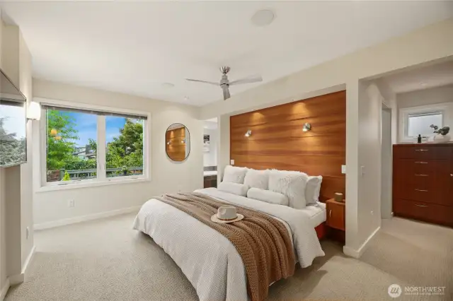 The Primary bedroom with wood accents adding warmth and functionality plus a large walk-in closet and private bathroom.