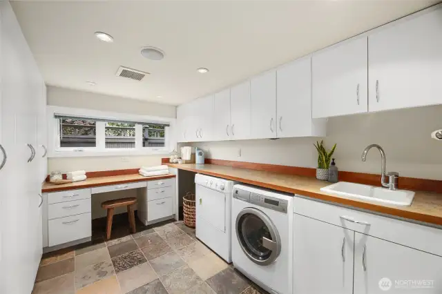 The lower-level laundry room with a ton of built-in cabinets to store all your things.