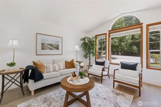 Living room has abundant natural light and a view of the greenbelt across the street.