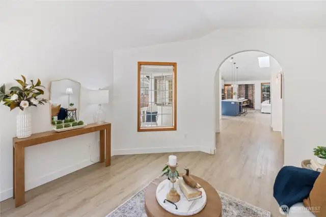 Looking from the living room into the kitchen. The window shows a view of the front porch.