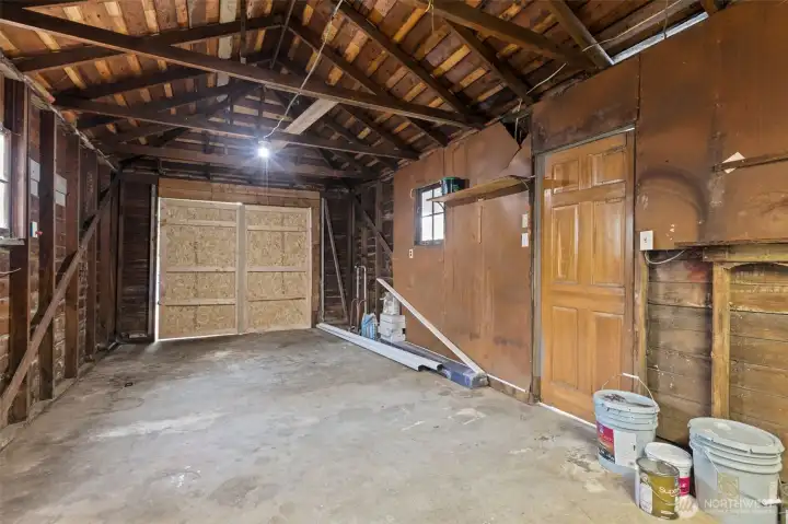 Detached garage with shop area provides access for your car from the alley!